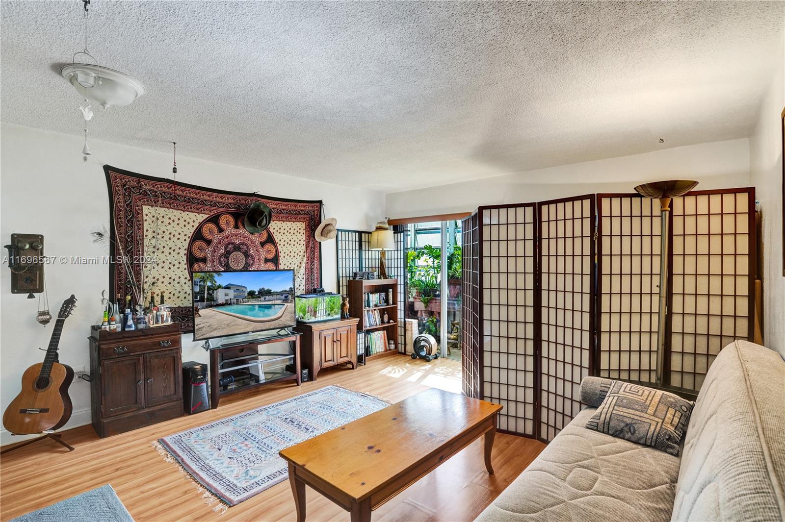 a living room with furniture a rug and a flat screen tv