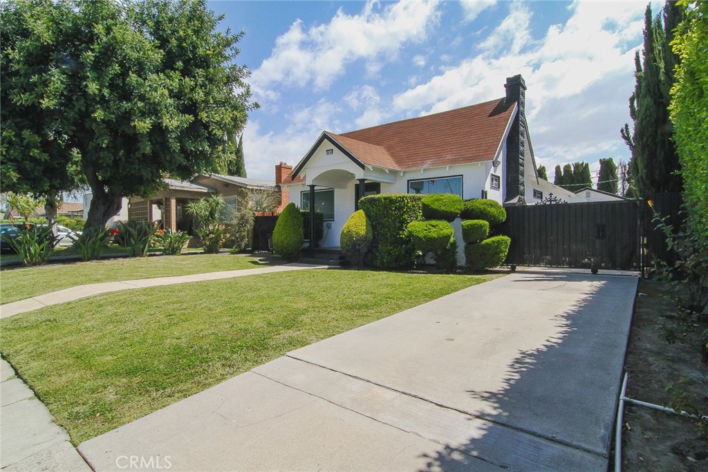 a front view of house with yard and green space