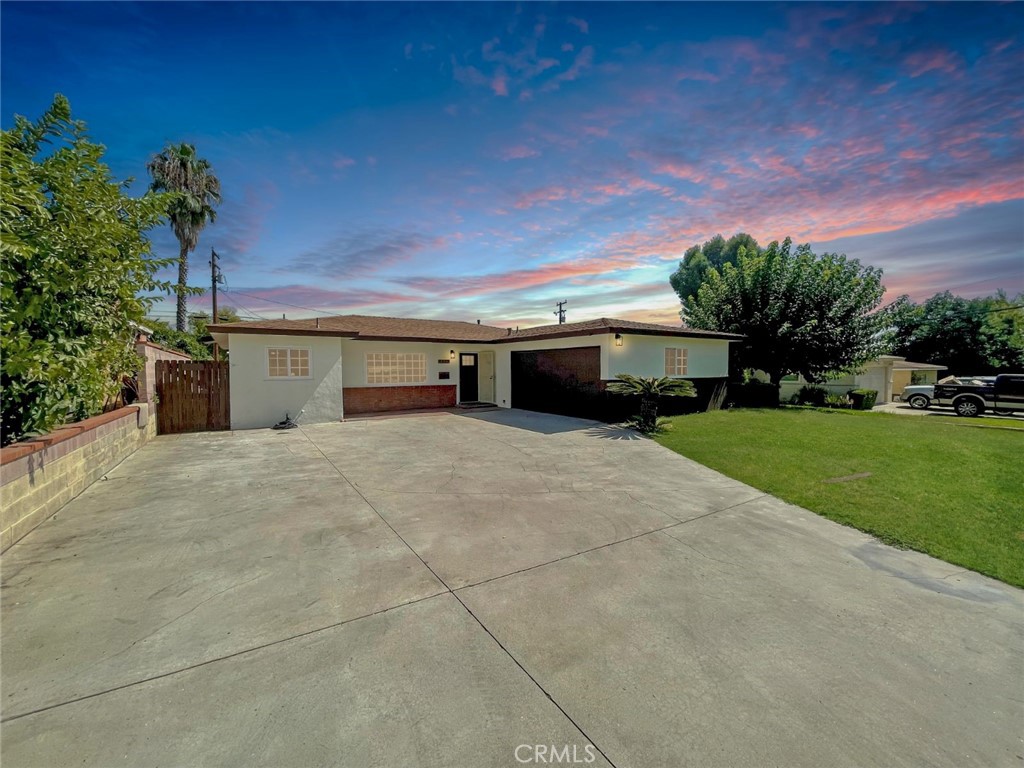 a front view of a house with a yard and a garage