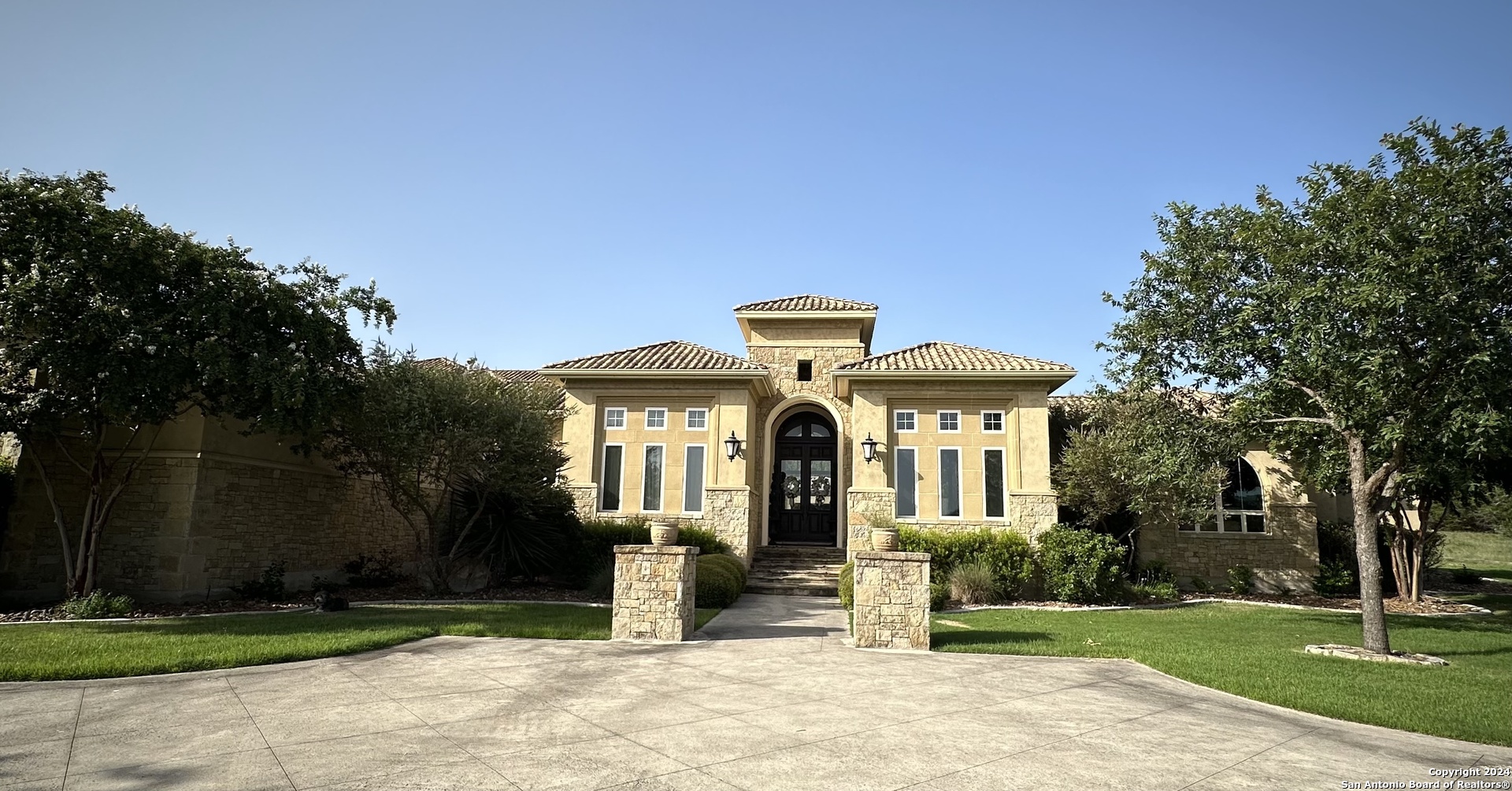 a front view of a house with a garden