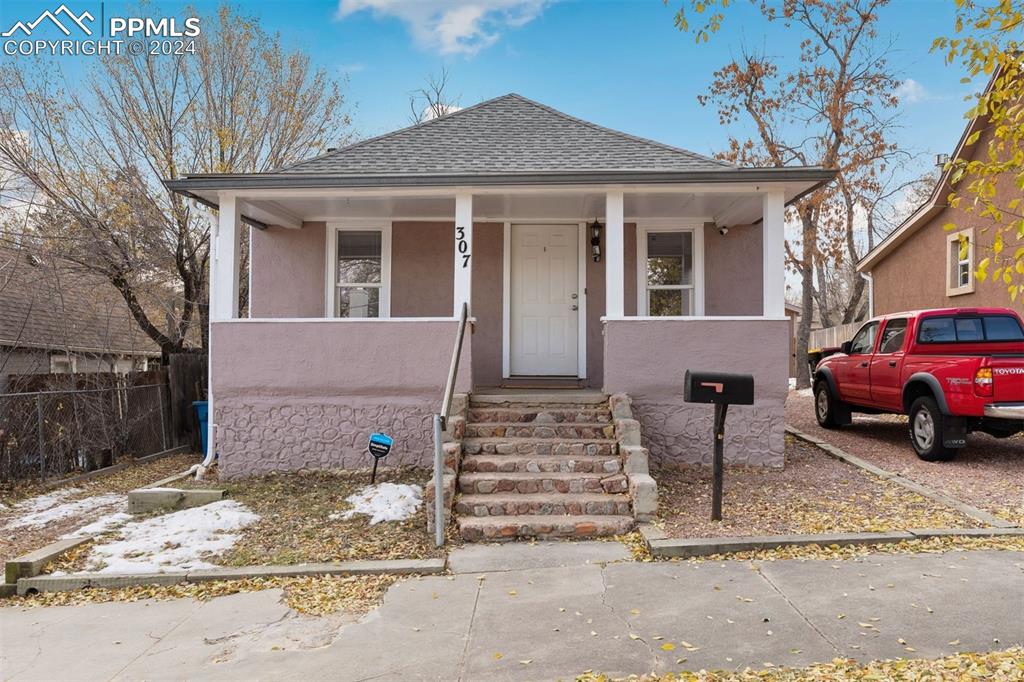 Bungalow with covered front porch that faces West with mountain views.