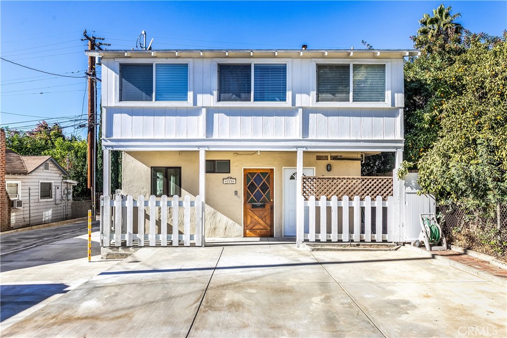 a front view of a house with a fence