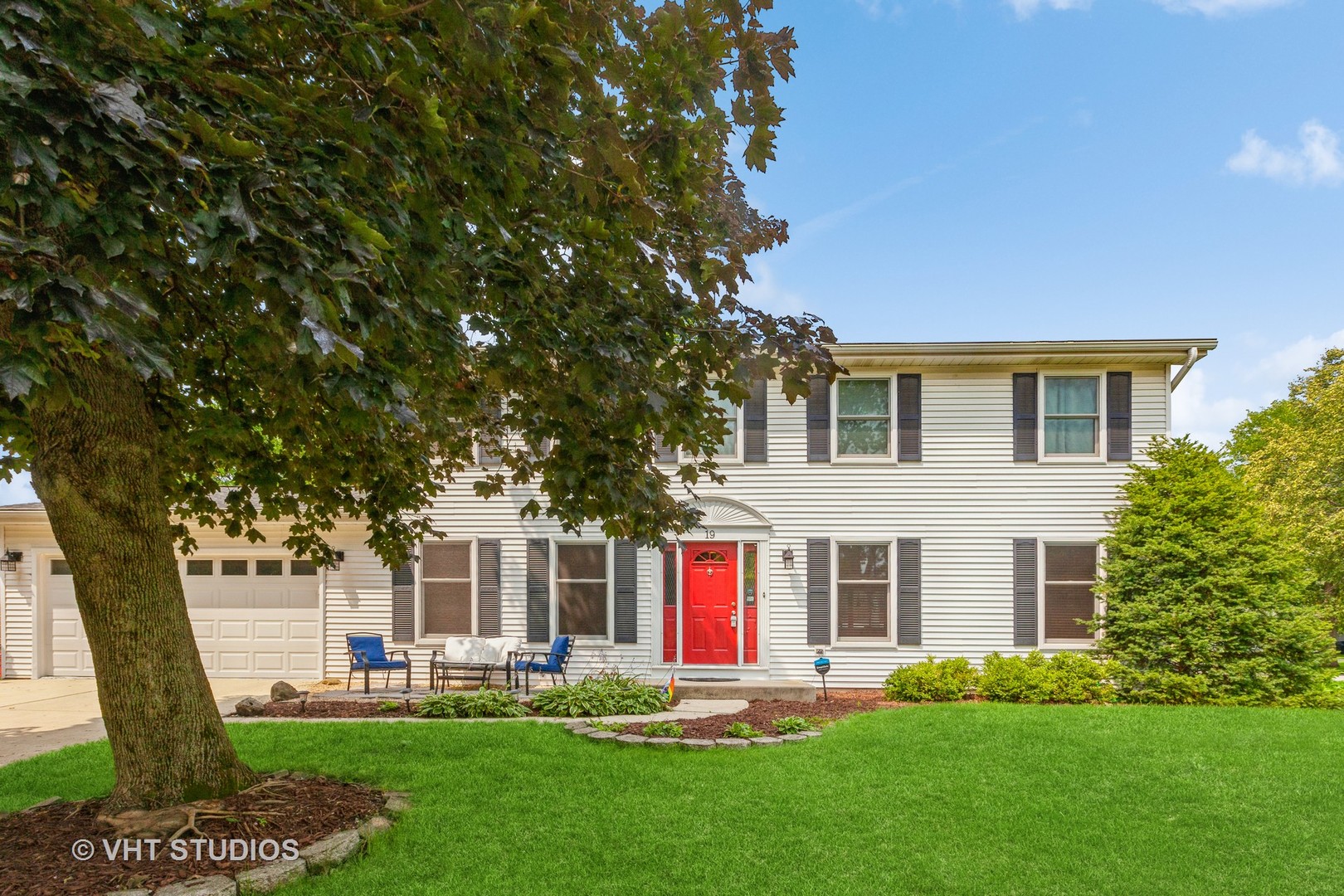 a front view of house with yard and green space