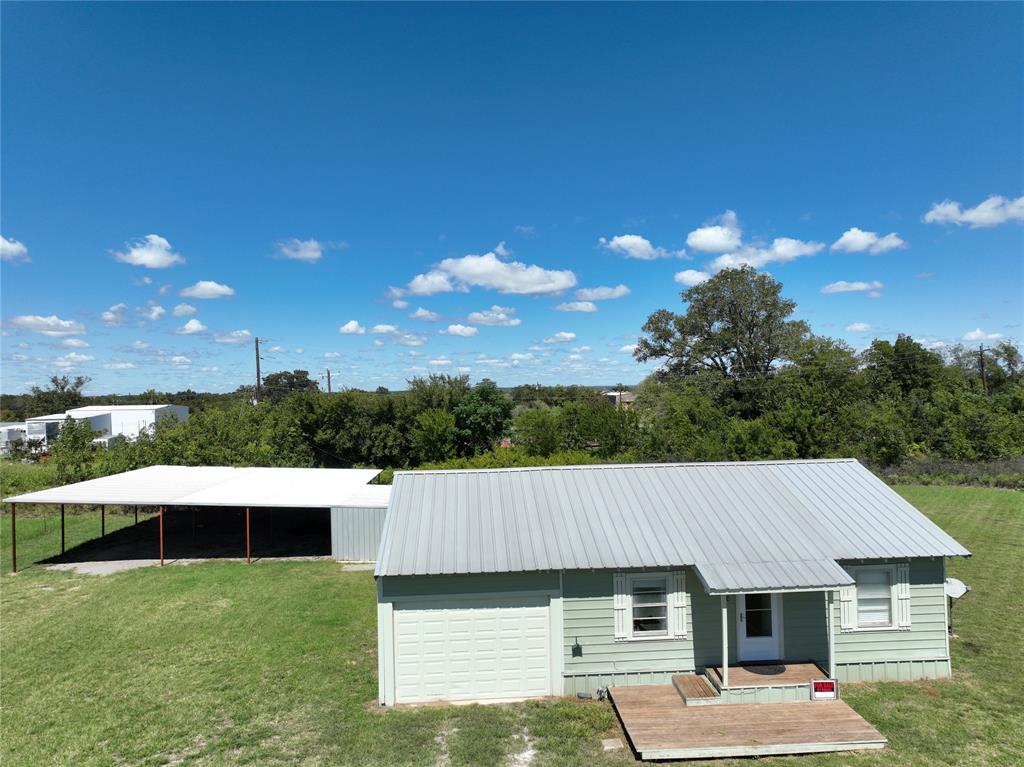 a view of house with backyard space and garden