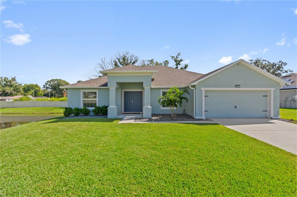 a front view of a house with a yard and garage