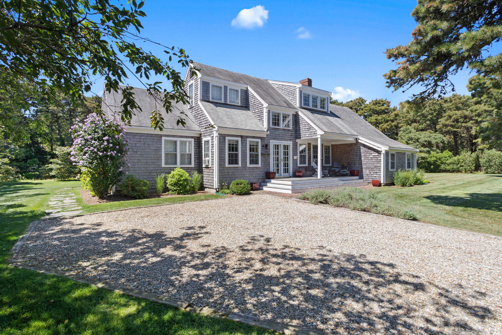 a front view of house with yard and green space