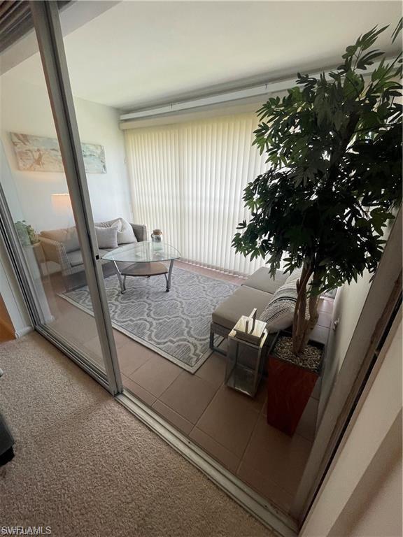 a view of living room with furniture and a floor to ceiling window