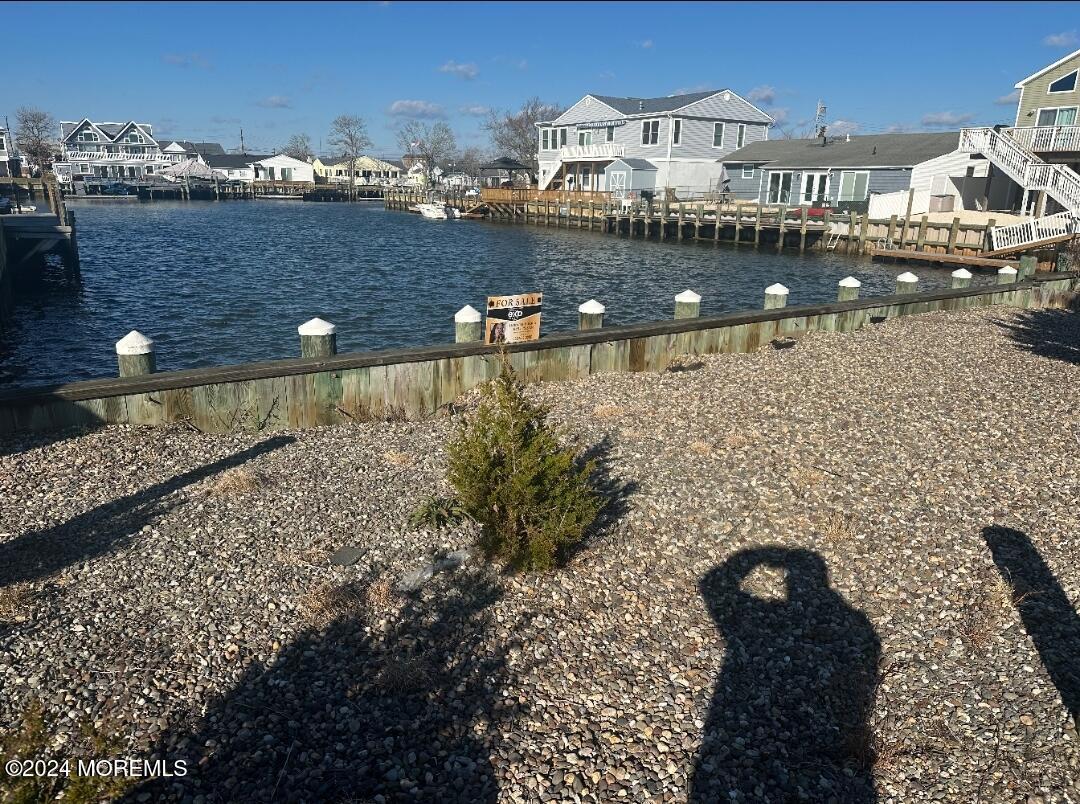 a view of a lake with a building and outdoor seating