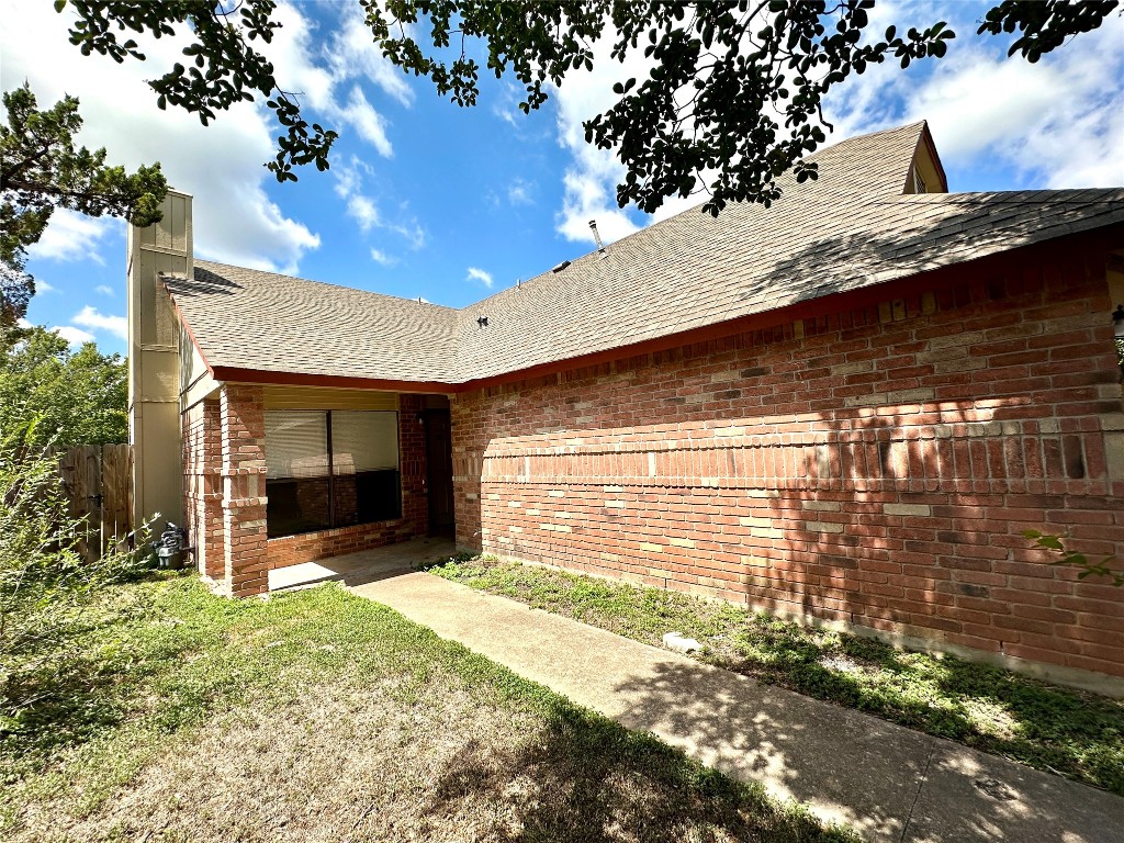 a view of a house with a door and wooden walls