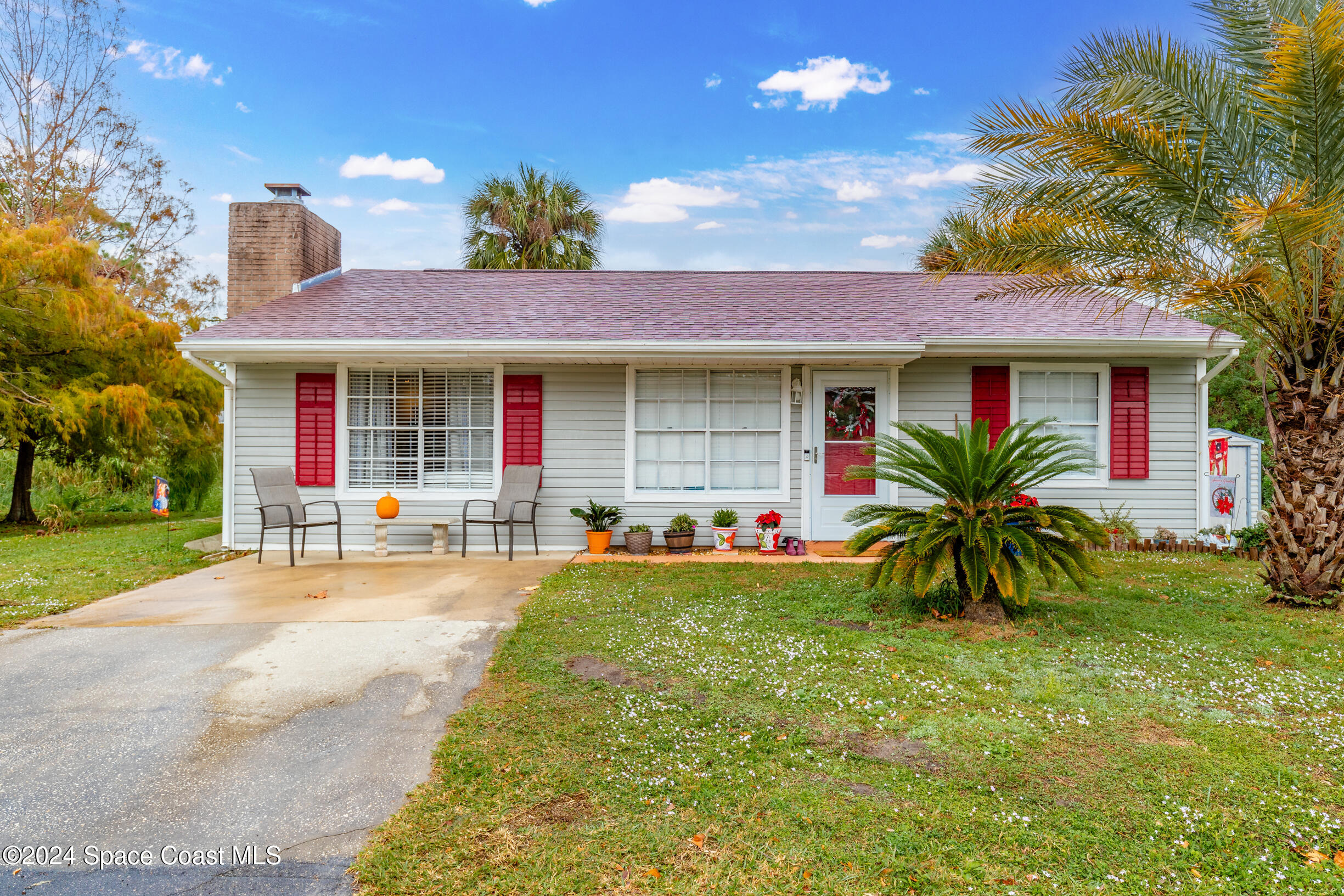 a front view of house with yard and outdoor seating