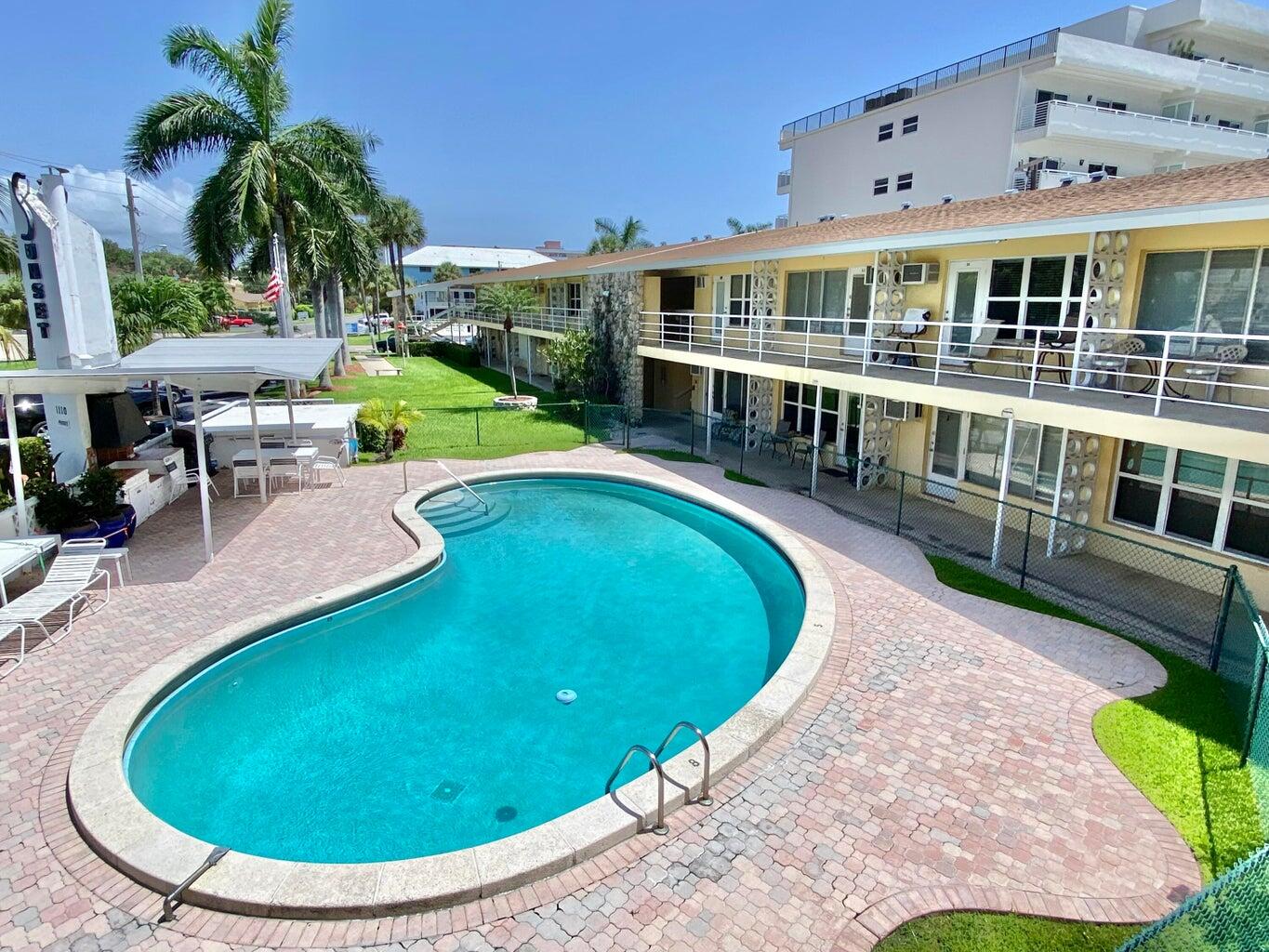 an aerial view of a house with swimming pool and glass doors