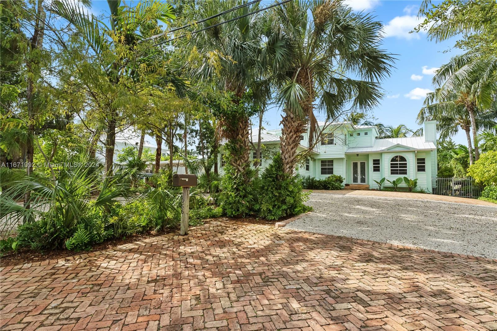 a view of a building with a yard and trees