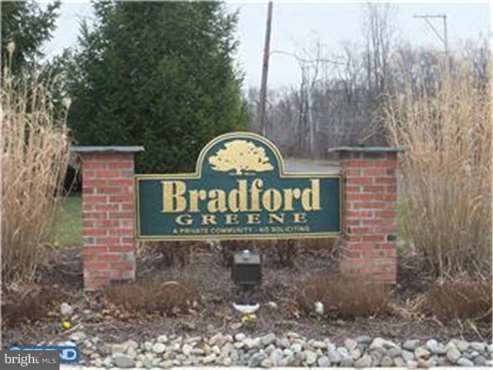 a sign broad in front of a brick building