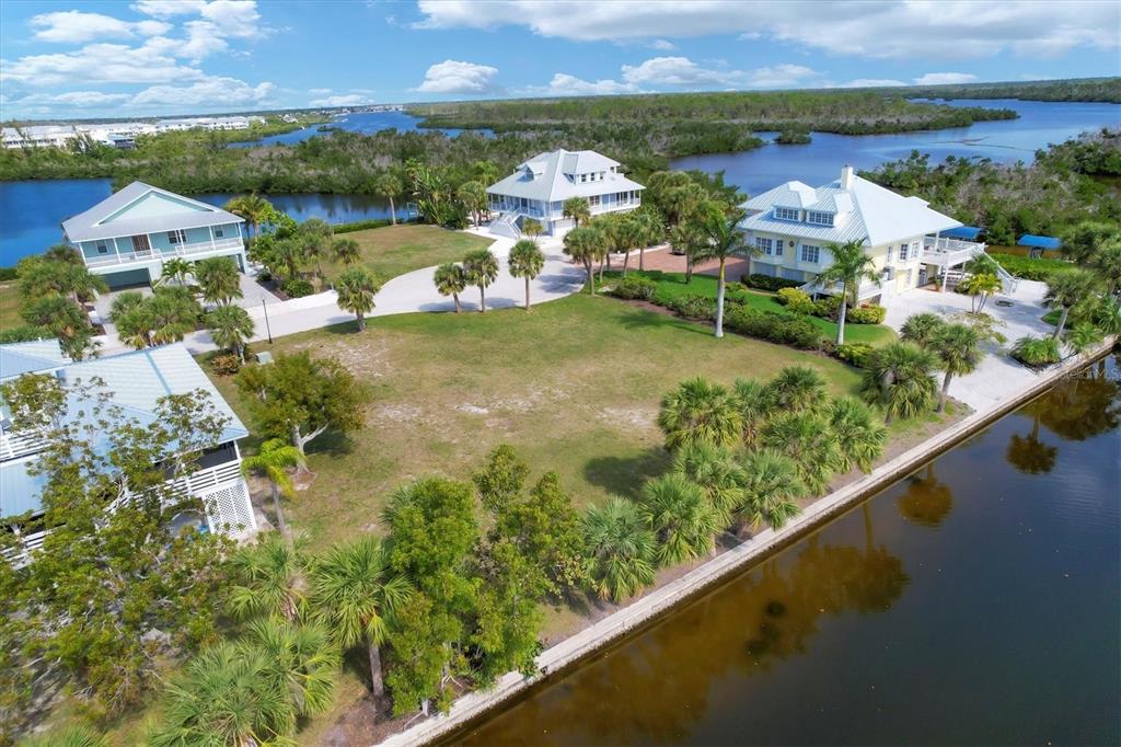 an aerial view of residential houses with outdoor space and river