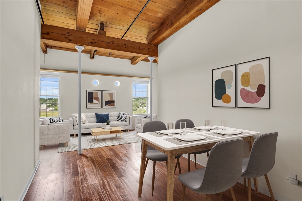 a view of a dining room with furniture window and wooden floor