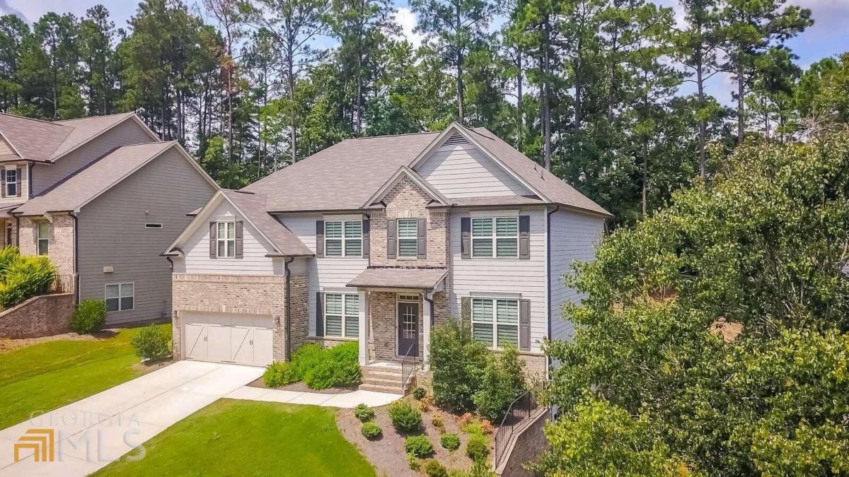 a aerial view of a house next to a yard