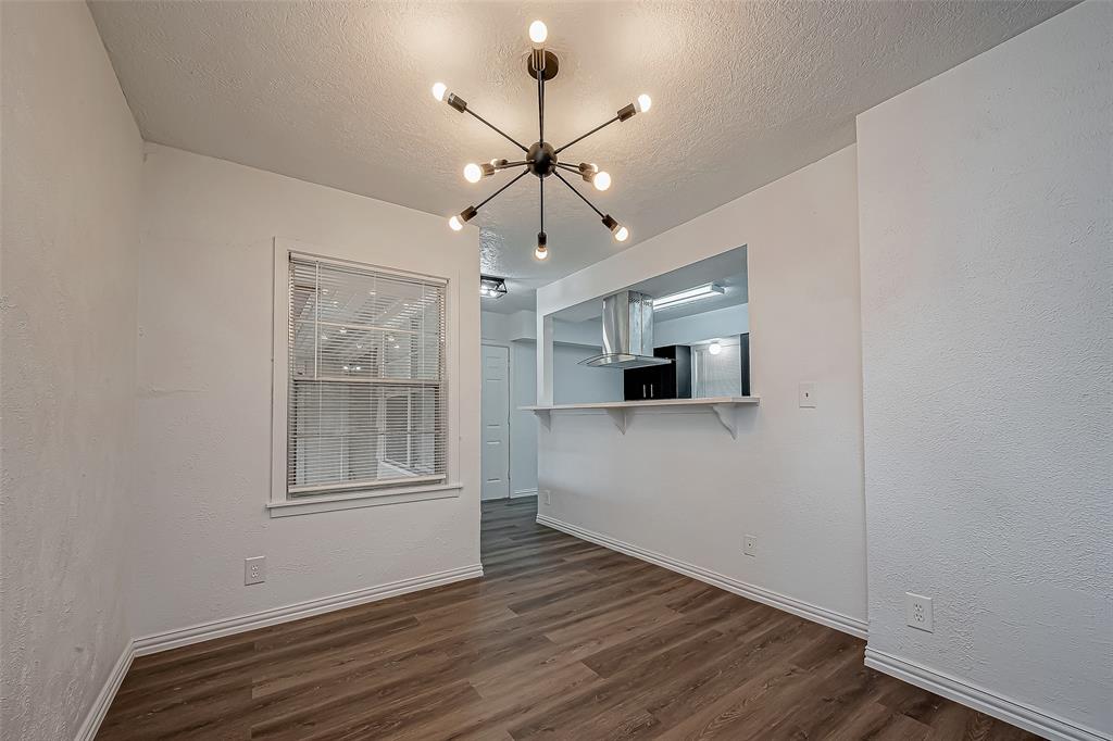 a view of empty room with wooden floor and ceiling fan