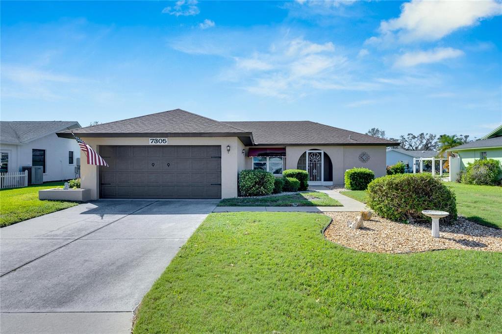 a front view of a house with a yard and garage