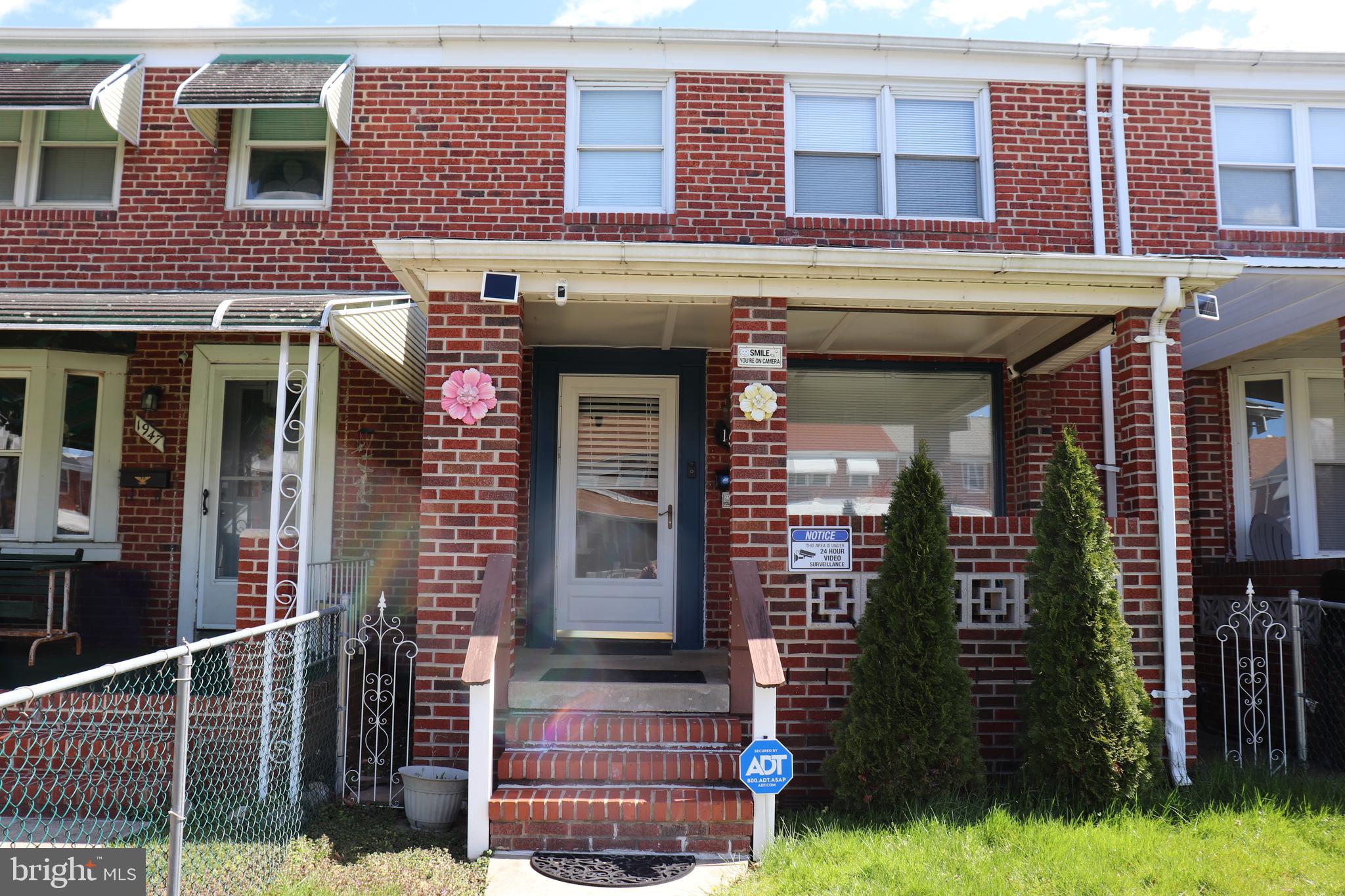 a view of brick building with a yard