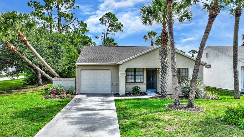 a front view of house with yard and green space