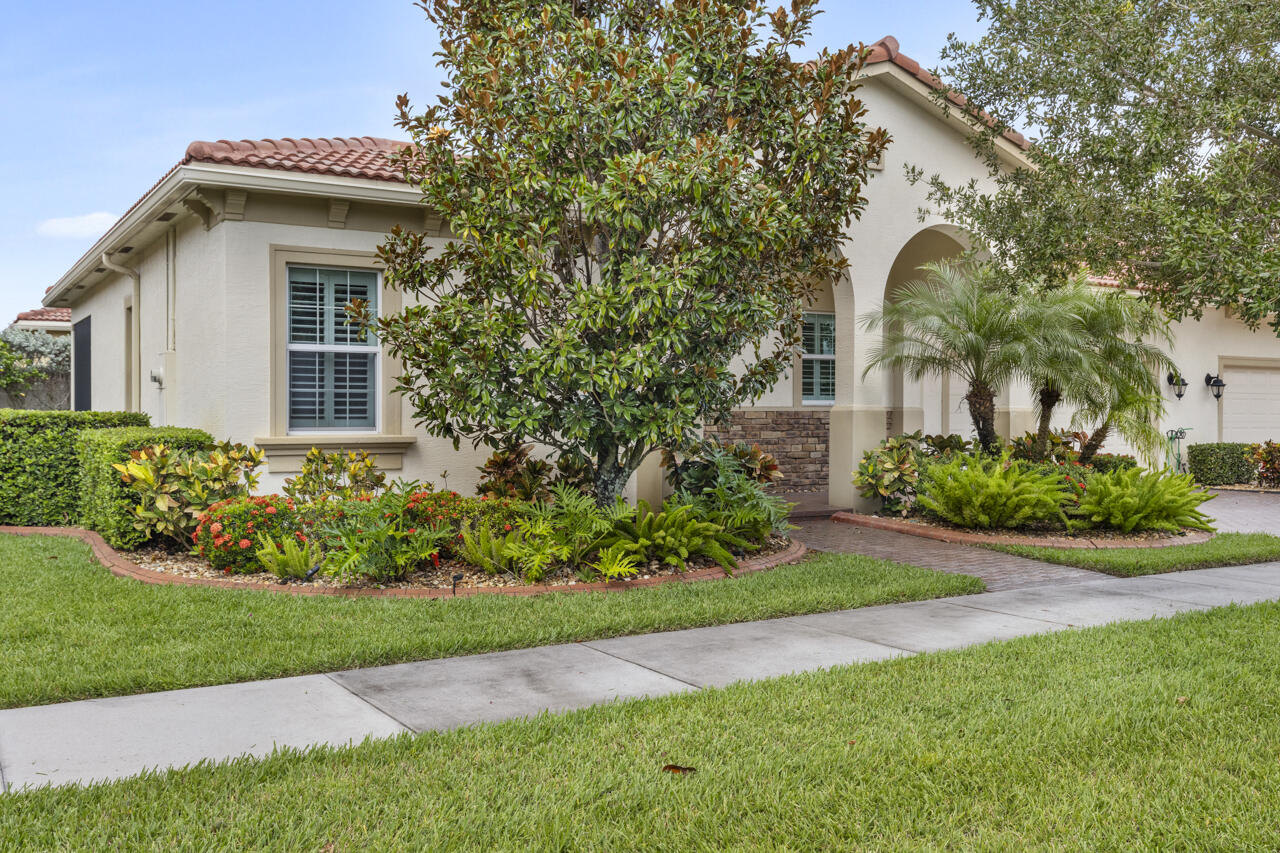 a front view of a house with a garden