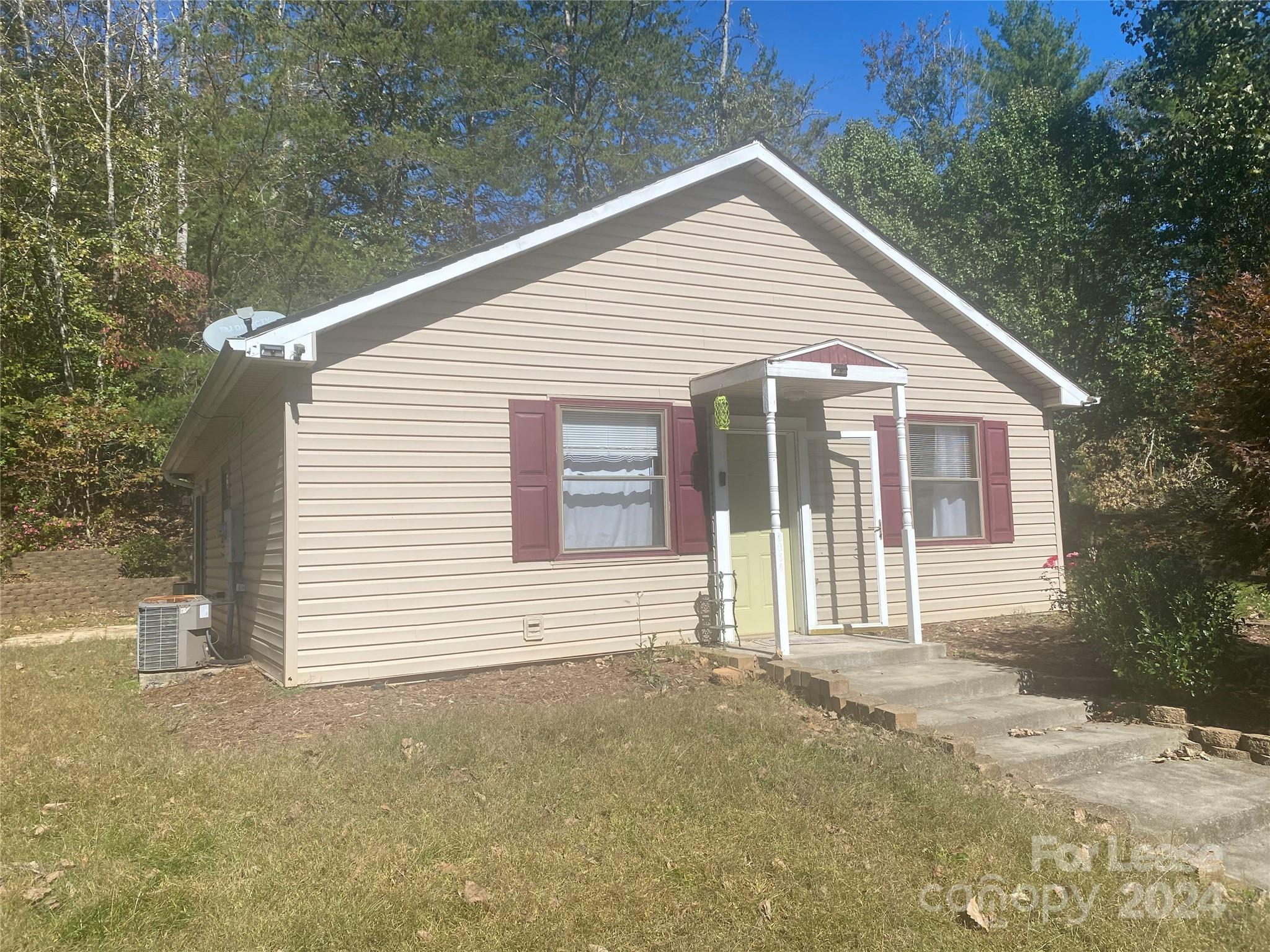 a view of a house with a yard and garage