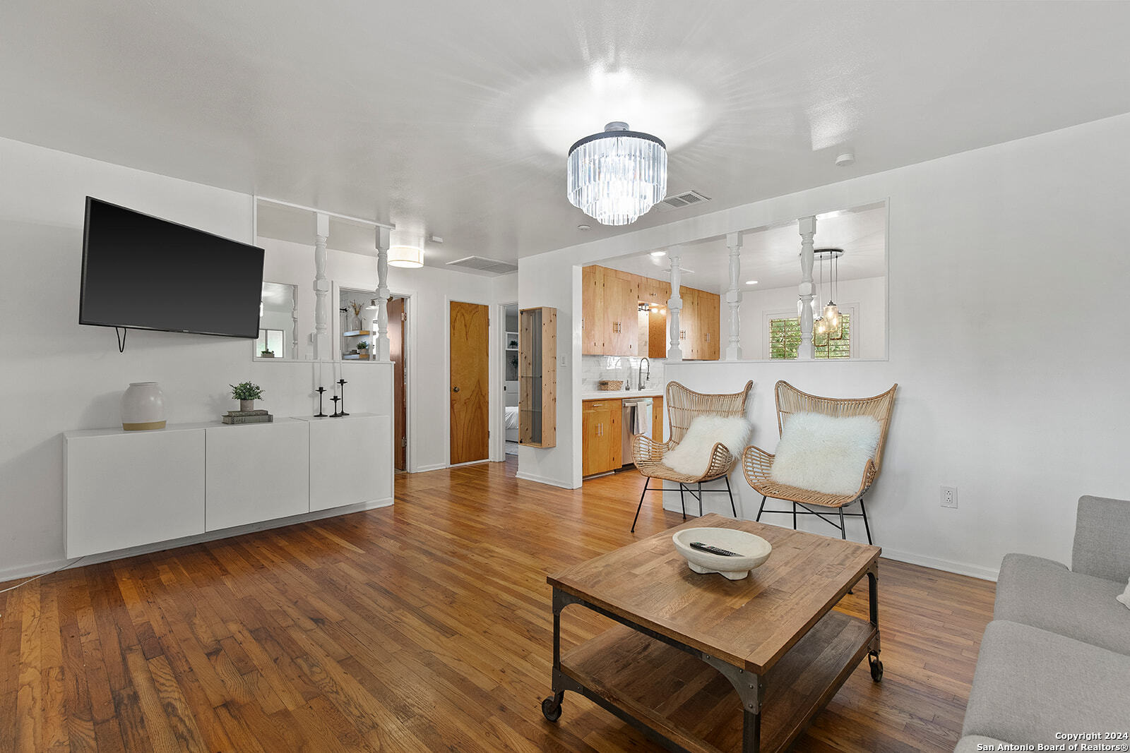 a living room with furniture and a flat screen tv