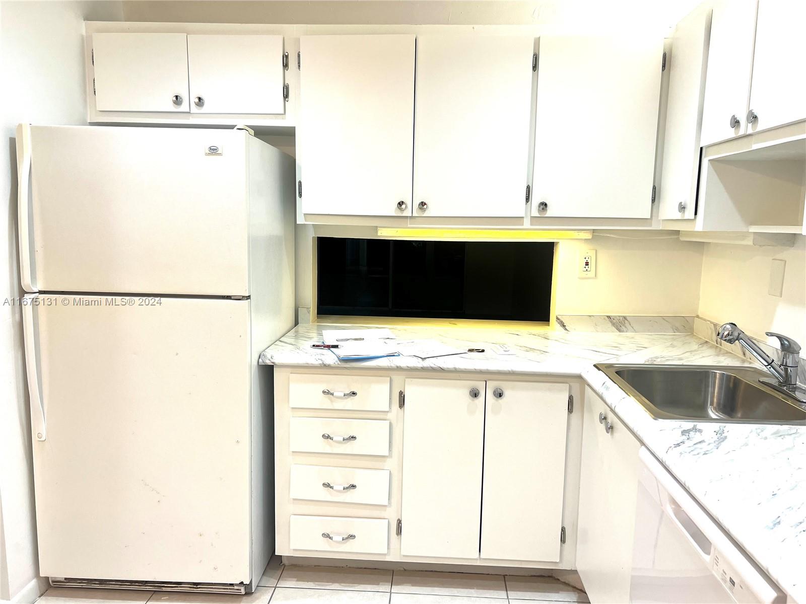 a kitchen with stainless steel appliances a refrigerator sink and cabinets