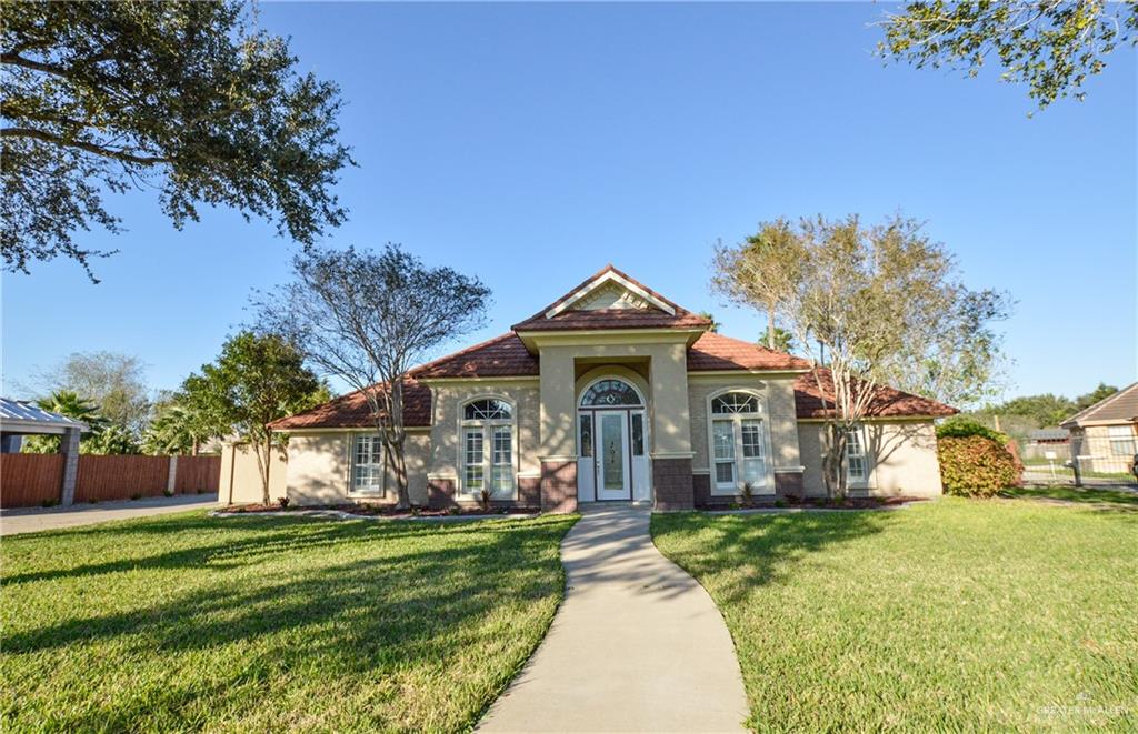 a front view of a house with a garden