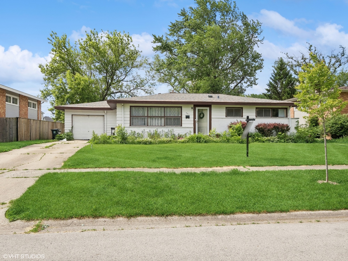 a front view of house with yard and green space