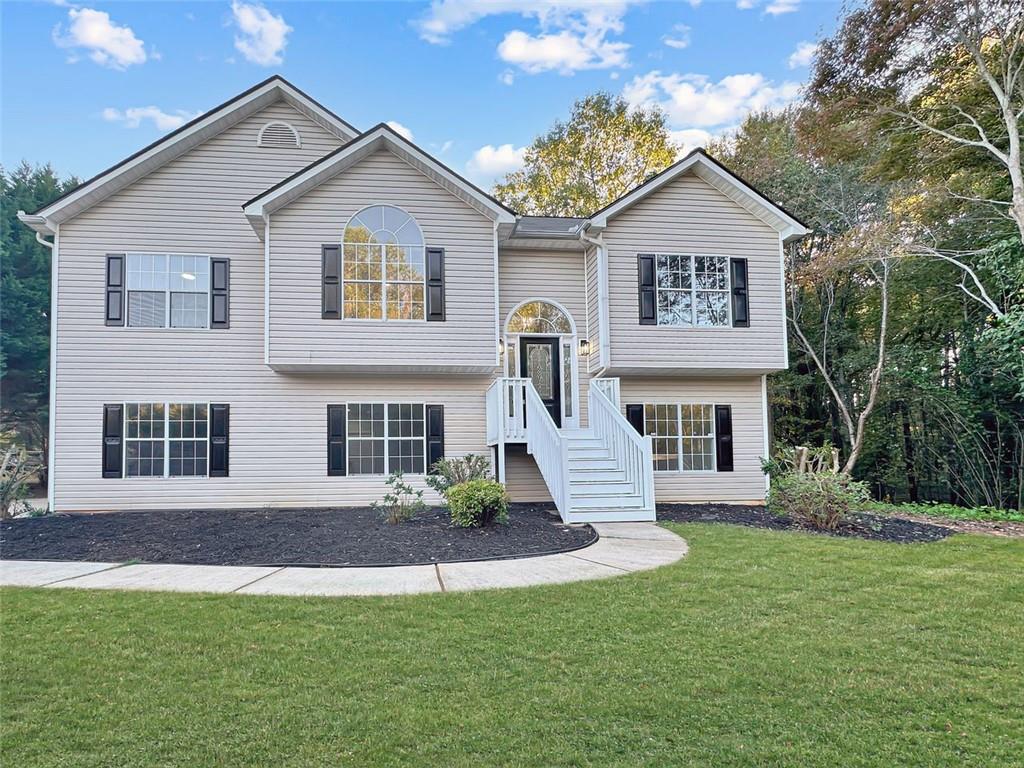 a front view of a house with a yard and garage