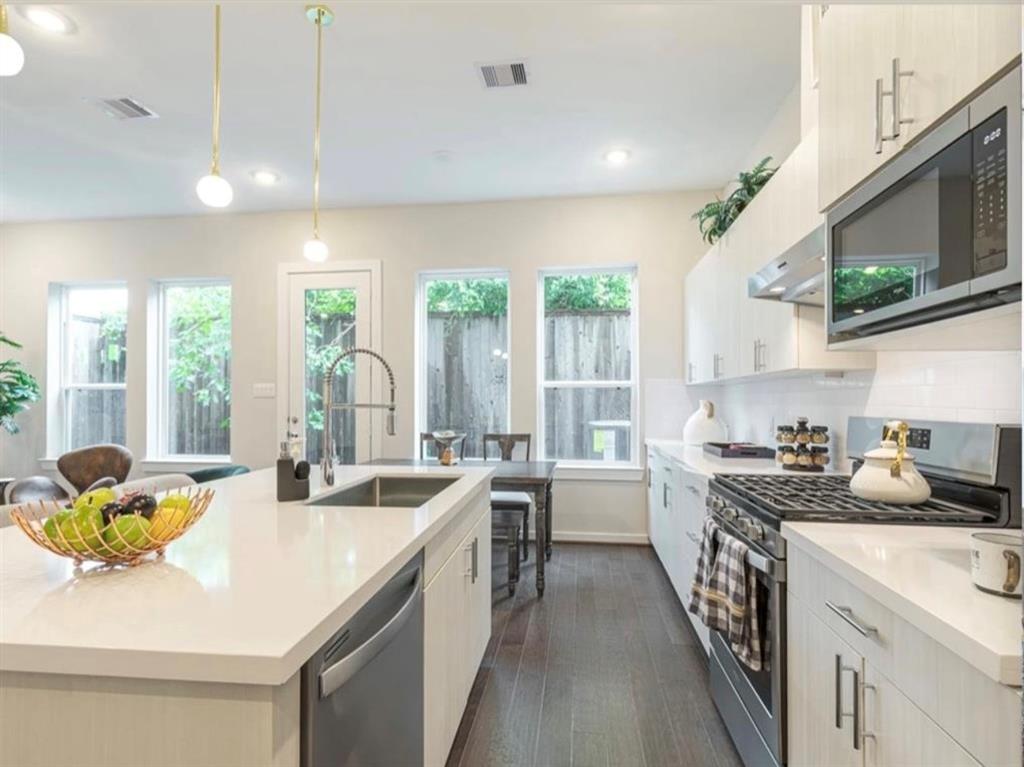 a kitchen with a sink stove and cabinets