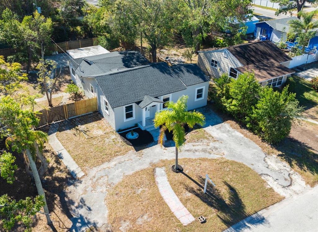 an aerial view of a house with a yard and garden