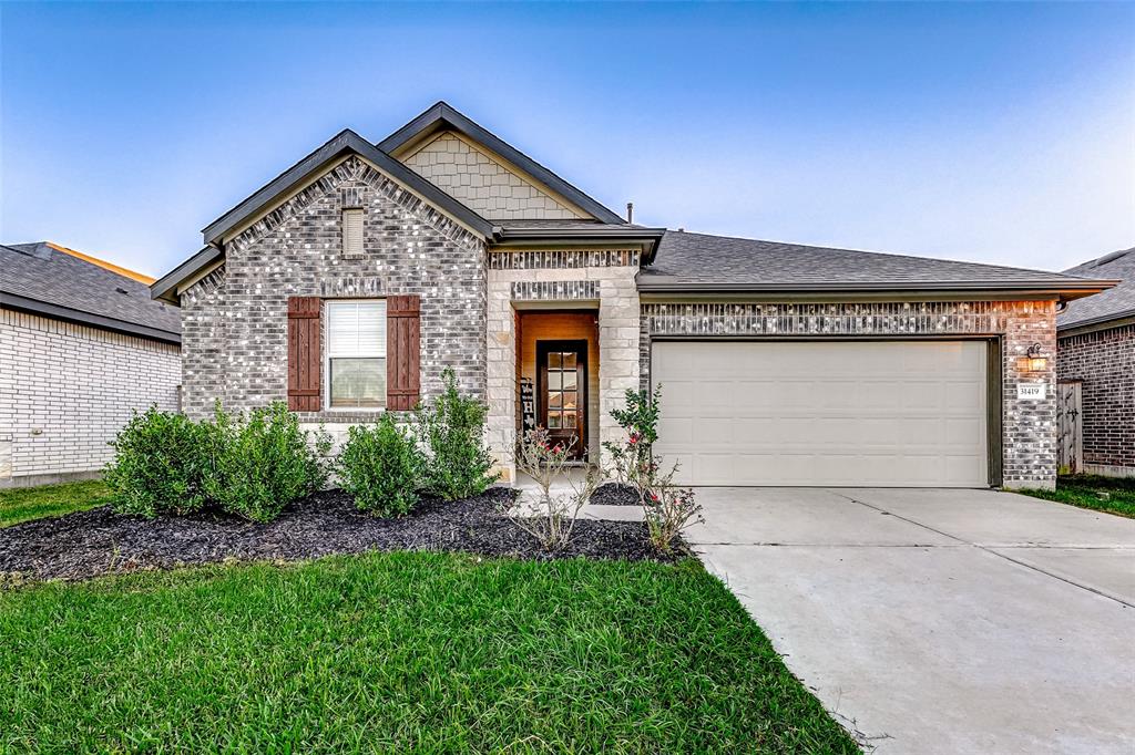 Welcome to 31419 Cardrona Peak Place, a home that greets you with its modern charm and thoughtfully landscaped exterior. This Ashton Woods design in Dellrose is a standout in the neighborhood, offering an effortless blend of elegance and comfort.