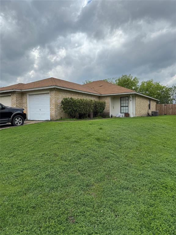 a view of a house with a yard and sitting space