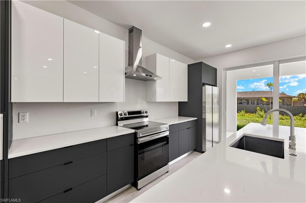 a kitchen with a sink a stove and a refrigerator