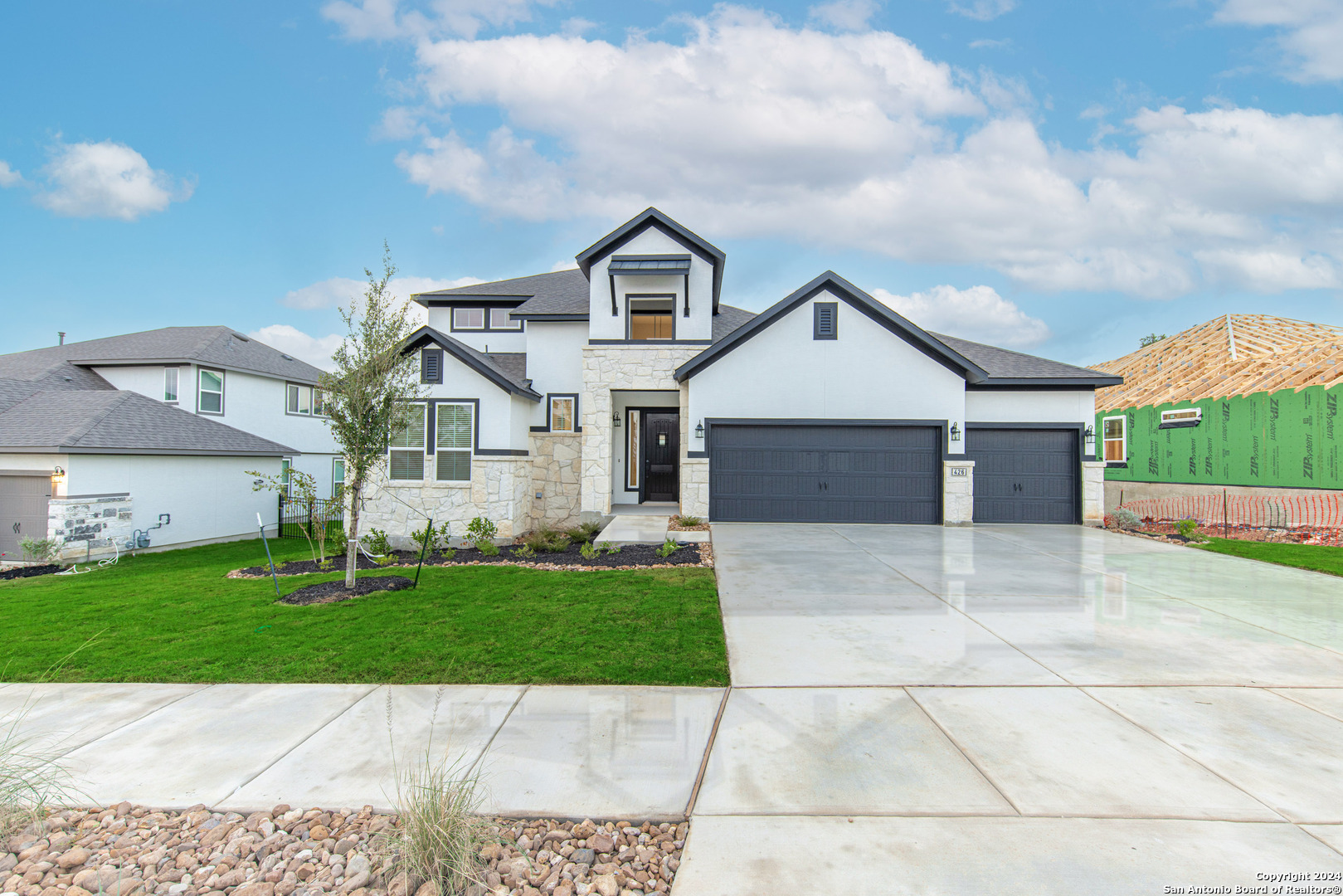 a front view of a house with a yard and garage