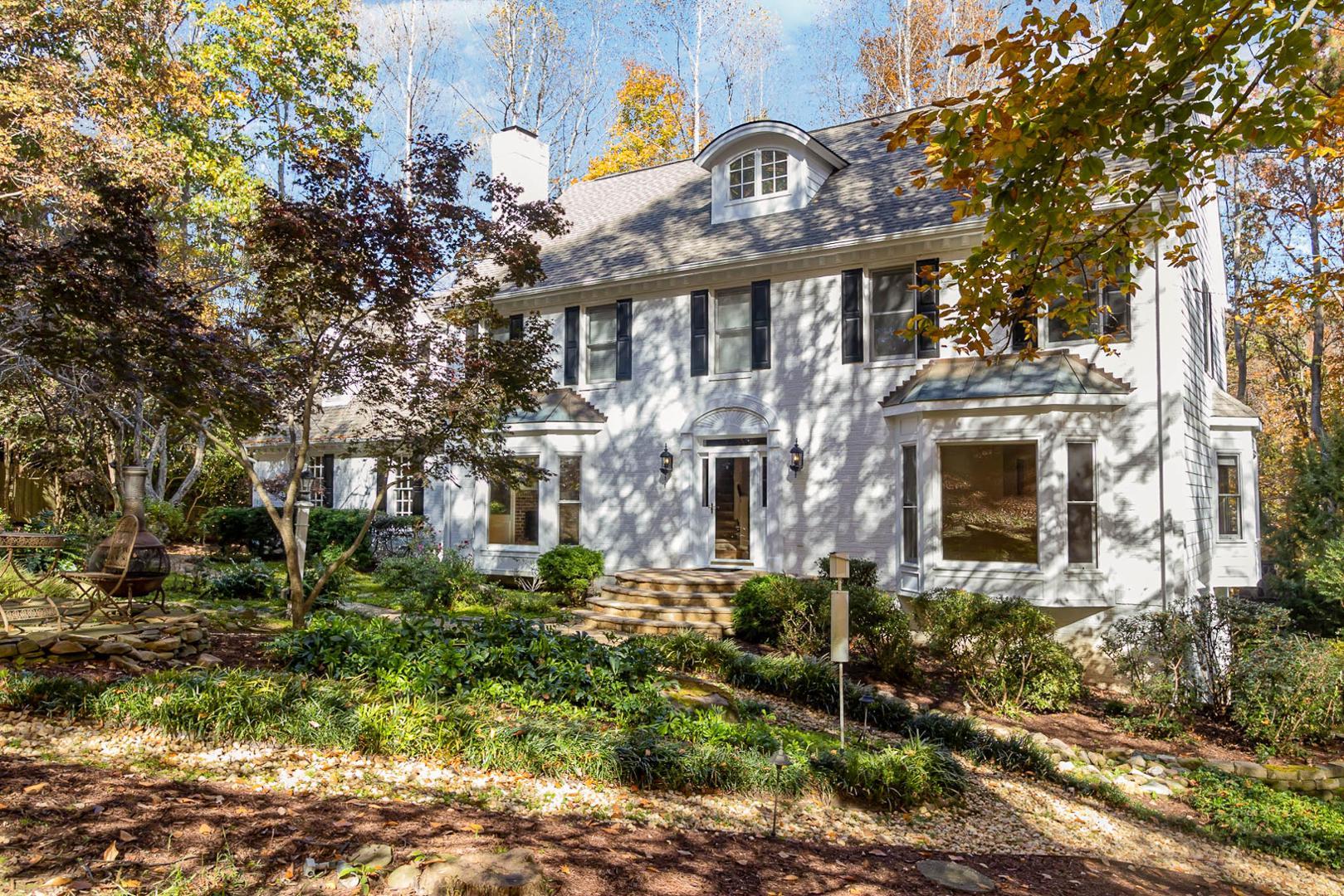 a front view of a house with a garden