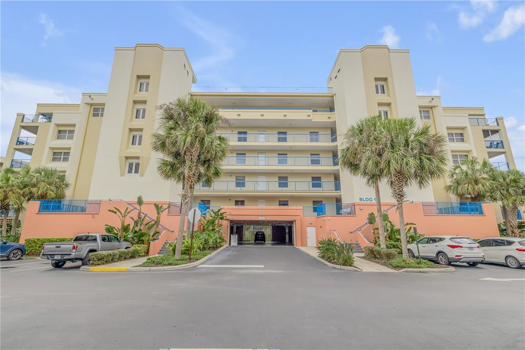 a front view of a building with palm trees