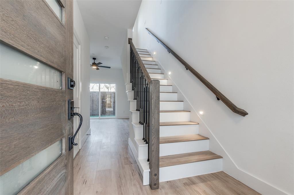 a view of entryway and hall with wooden floor