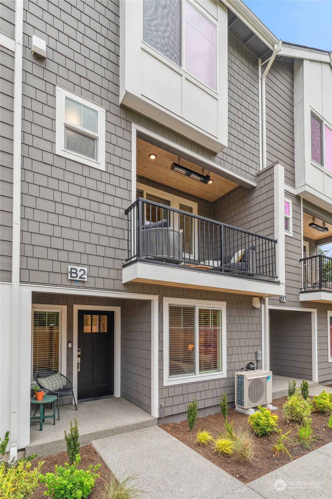 a front view of a house with a yard and outdoor seating