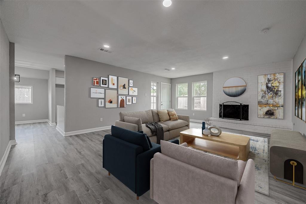 a living room with furniture and wooden floor