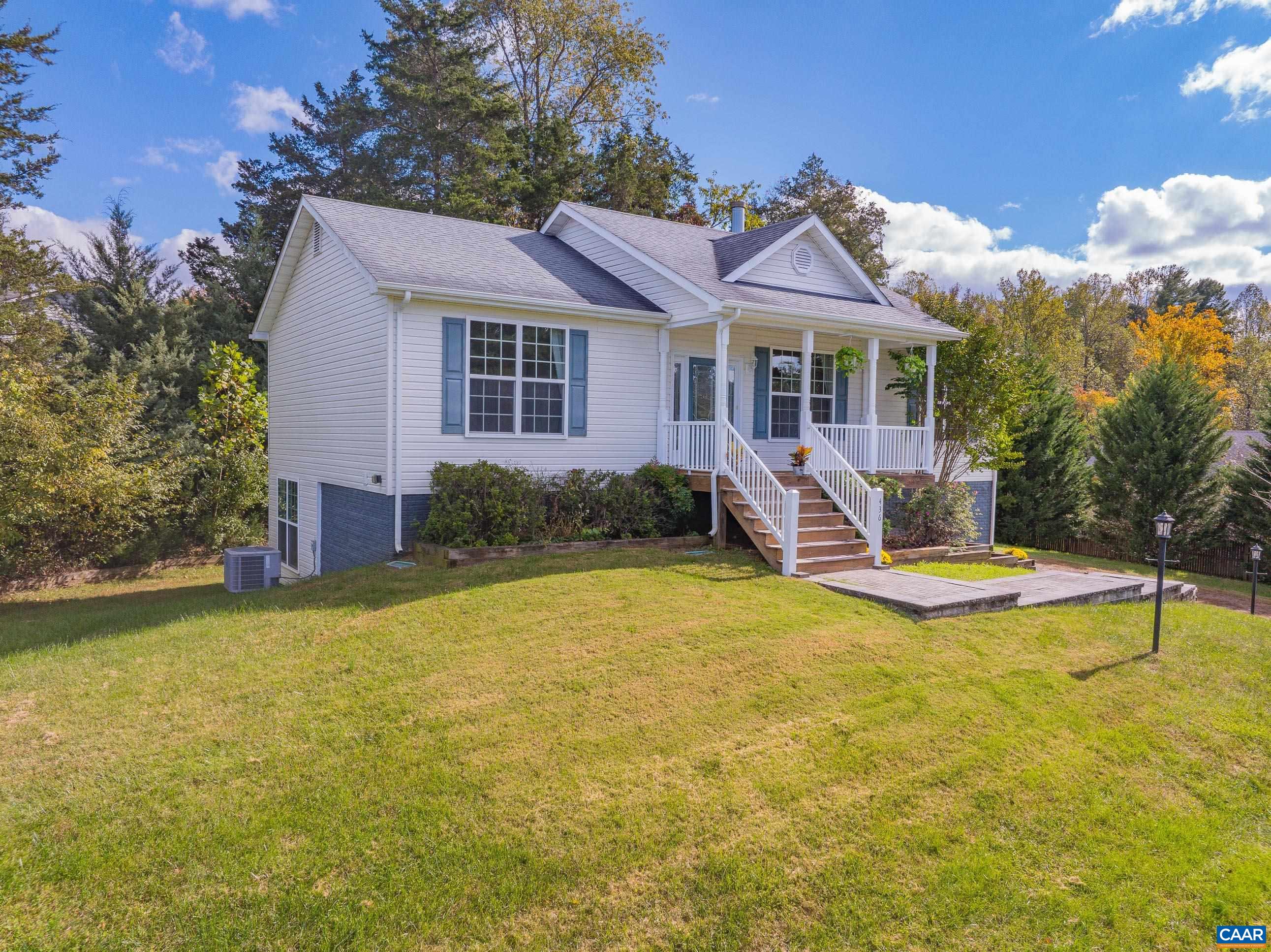 a front view of house with yard and outdoor seating