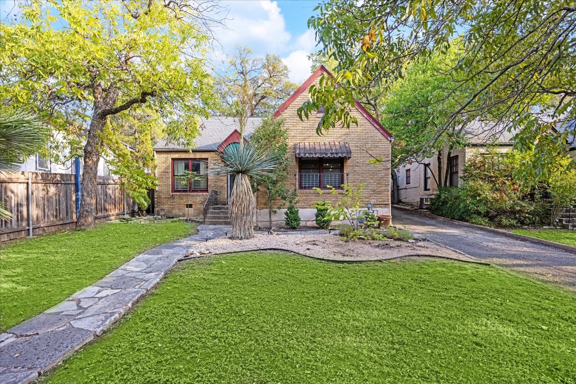 a front view of house with a garden and patio