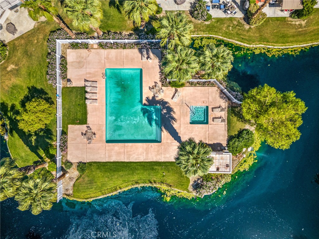 an aerial view of a house with a yard swimming pool and outdoor seating