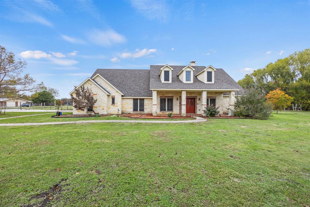 Cape cod home with a front yard and covered porch