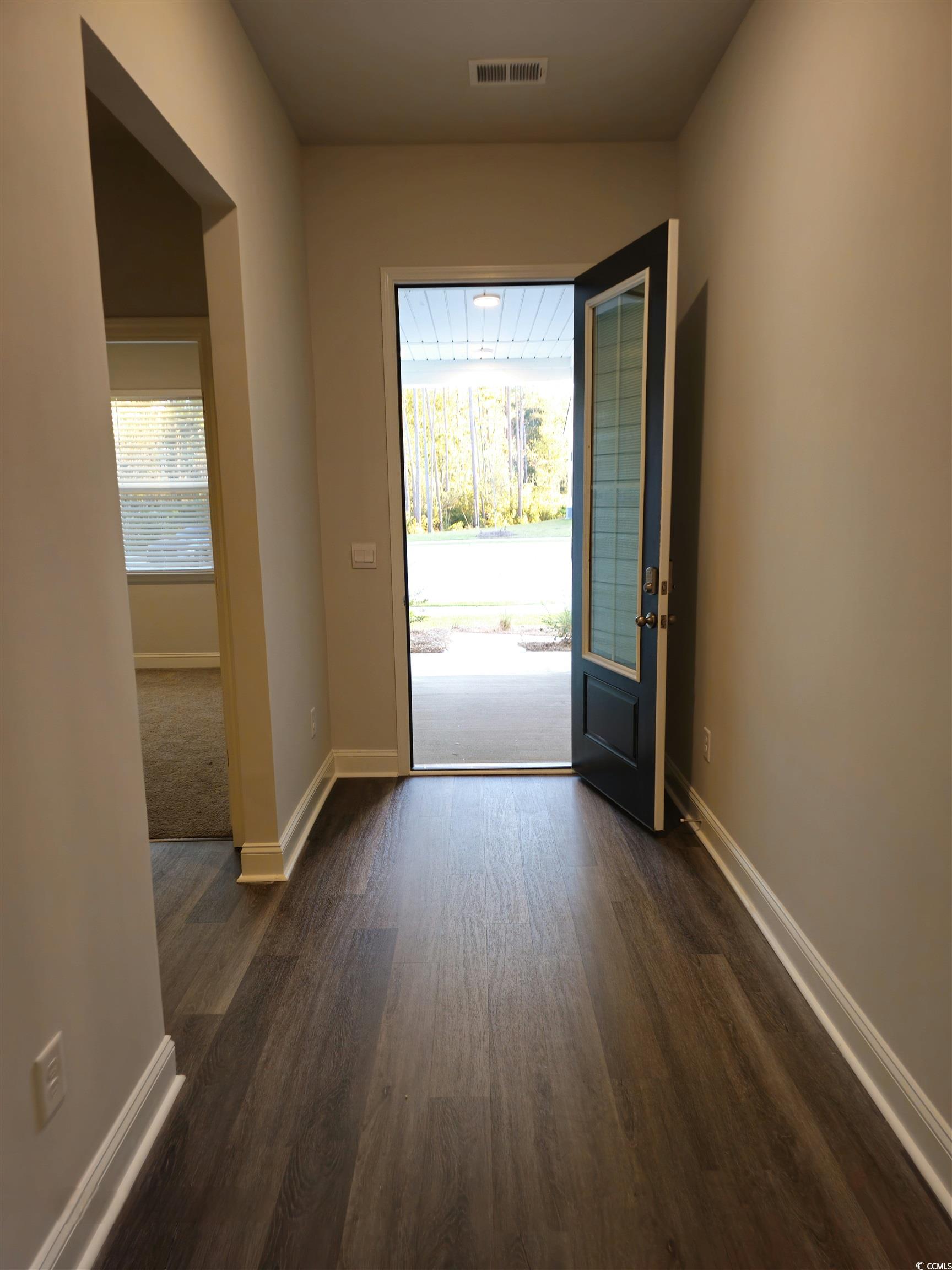 Entryway with dark wood-type flooring and a health