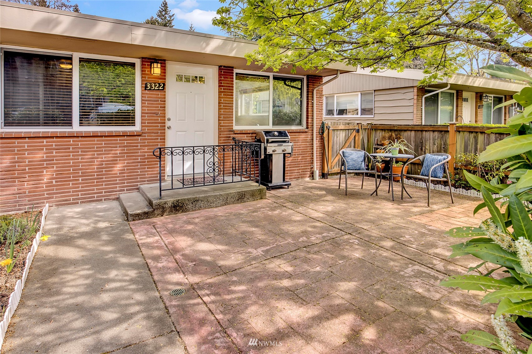 a view of a house with backyard and sitting area