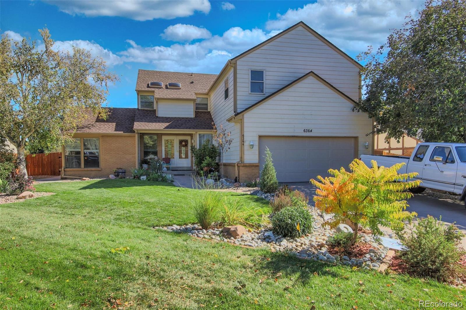 a front view of house with a garden