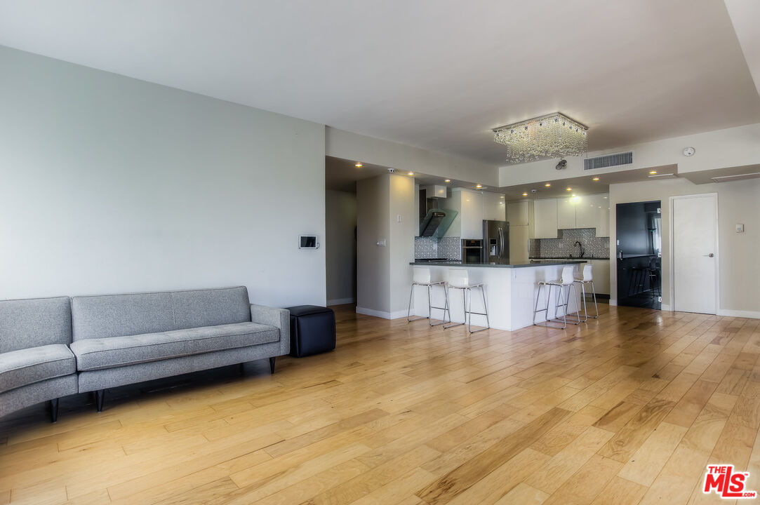 a view of kitchen with kitchen island microwave and refrigerator